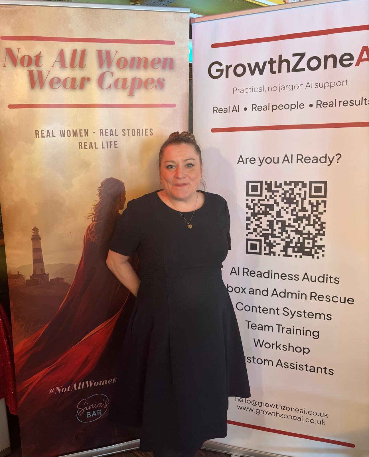 Kaye Nicholson standing between the Not All Women Wear Capes banner and the GrowthZone AI banner at Sinia's Bar